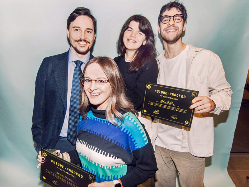 Four smiling individuals, likely Hive Helsinki alumni or graduates, proudly holding 'FUTURE-PROOFED AT HIVE HELSINKI' certificates or awards. This image highlights the success and career readiness of Hive Helsinki students who have completed their innovative tech education in Finland, ready to contribute to futureproofing the industry.
