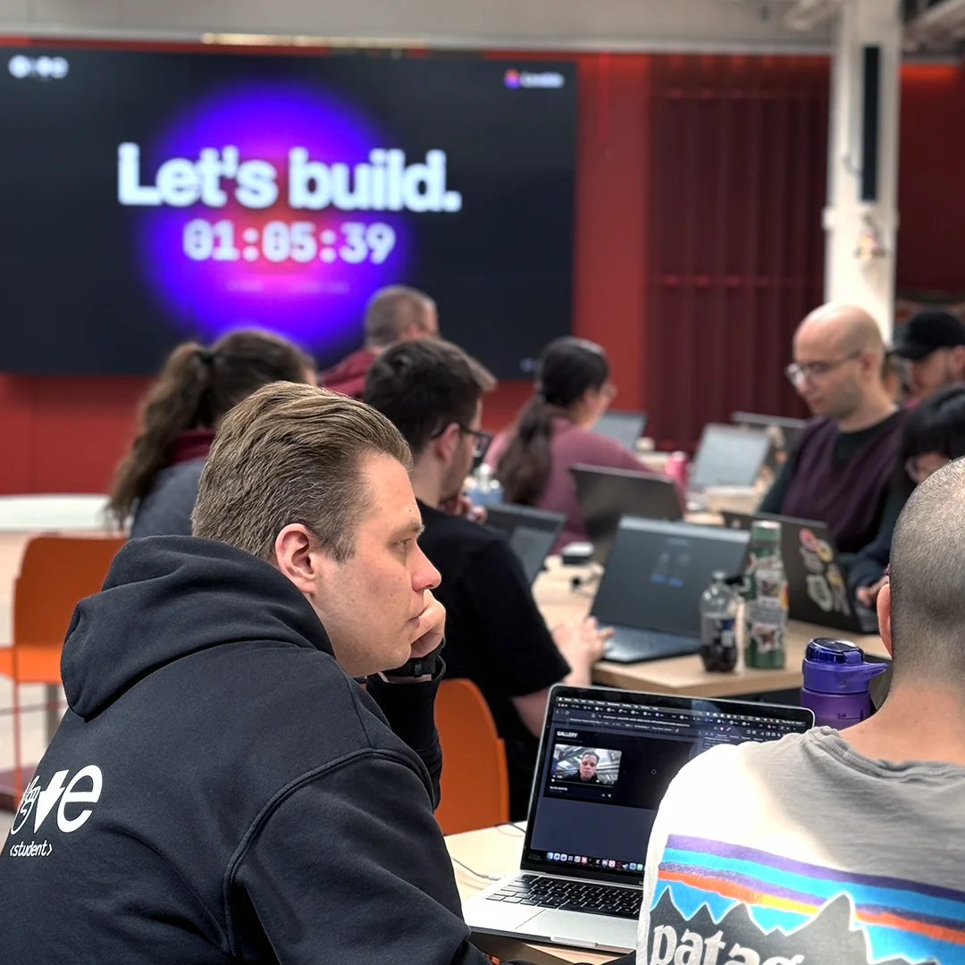 Students at a hackathon build session at Hive Helsinki, with a countdown timer on screen